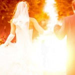 bride and groom is jumping with joined hands to the sunset (Newscom TagID: ipurestockxthree081164.jpg) [Photo via Newscom]